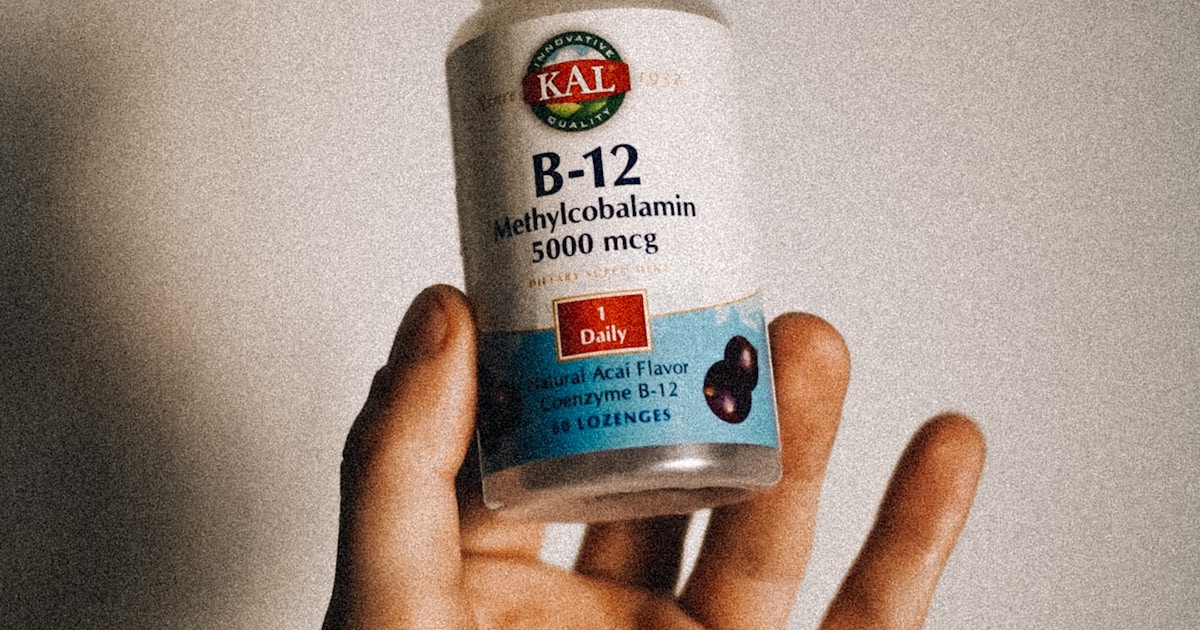 Persona sosteniendo suplemento de vitamina B12